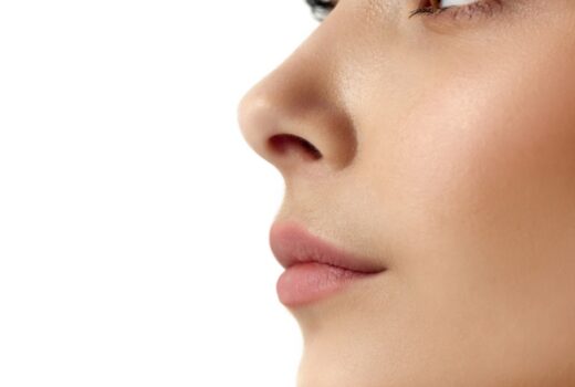 Cropped, close-up profile image of female face part, nose and lips against white studio background. Rhinoplasty plastic surgery. Concept of female beauty, body and skincare, cosmetology, health, ad
